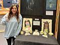  Kenmore East senior Maya Gentile poses in front of her artwork.